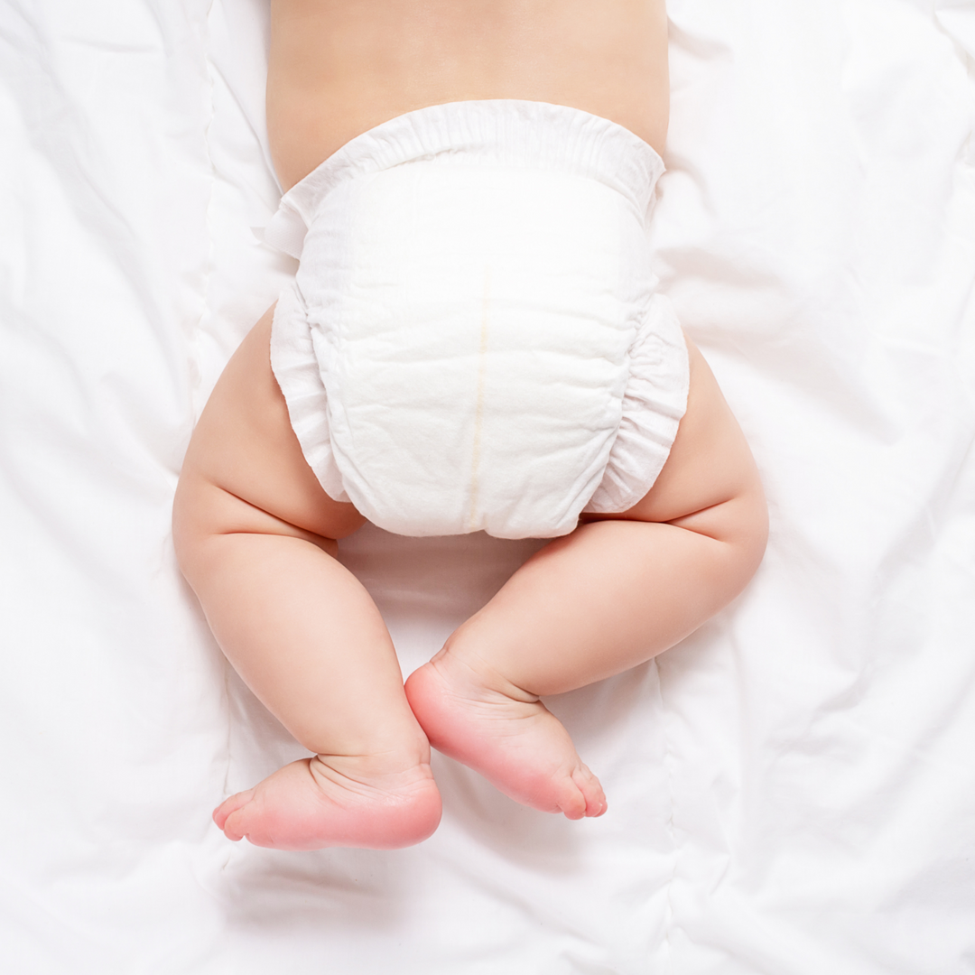 Baby wearing a white diaper on a white background