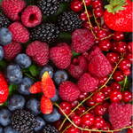 Assorted berries including raspberries, blackberries, and strawberries on a dark background