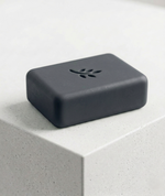 Black rectangular soap with a flower print design on a light gray surface