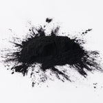 Black charcoal powder on a white background