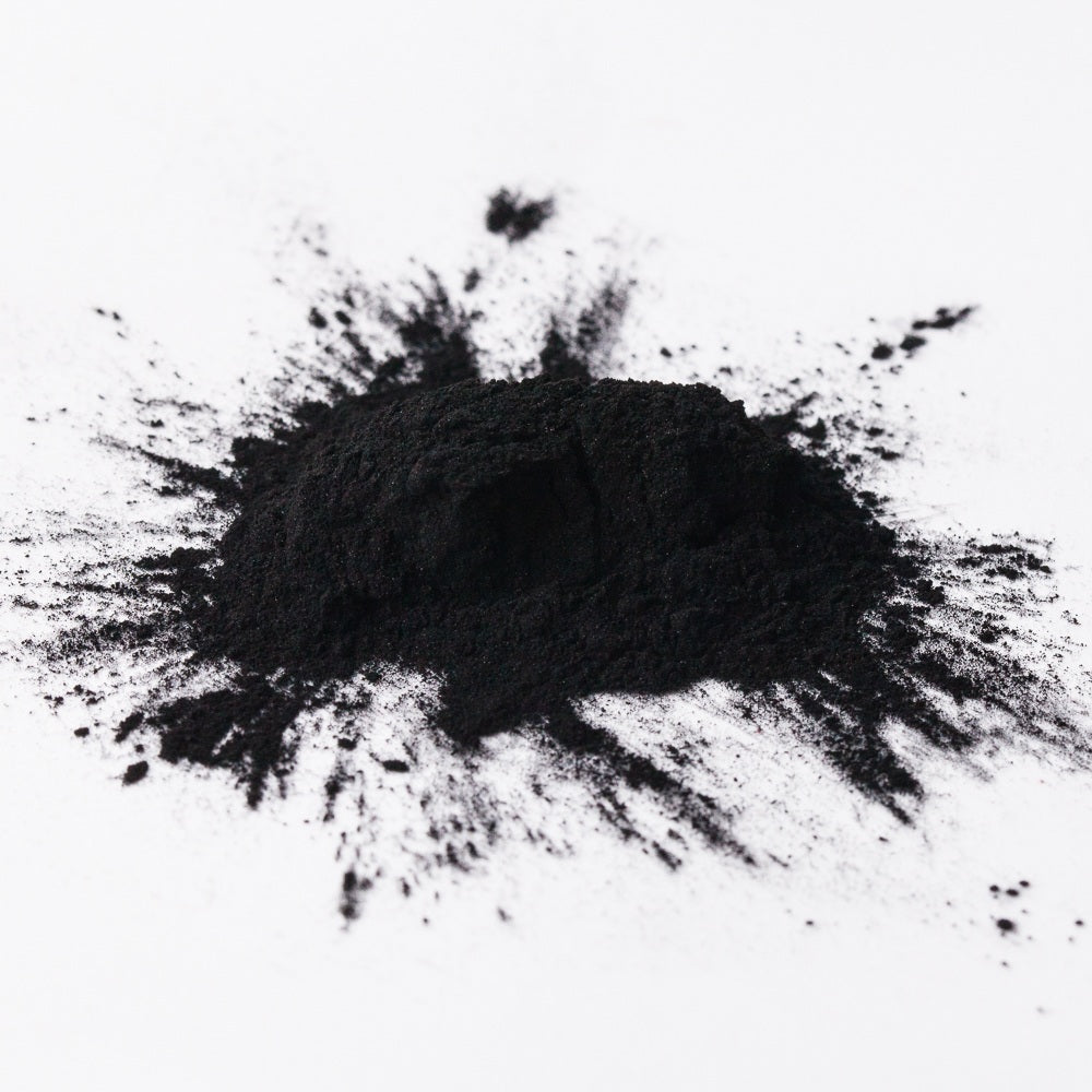 Black charcoal powder on a white background