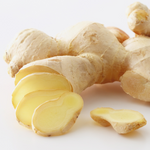 Whole and sliced ginger root on a white background