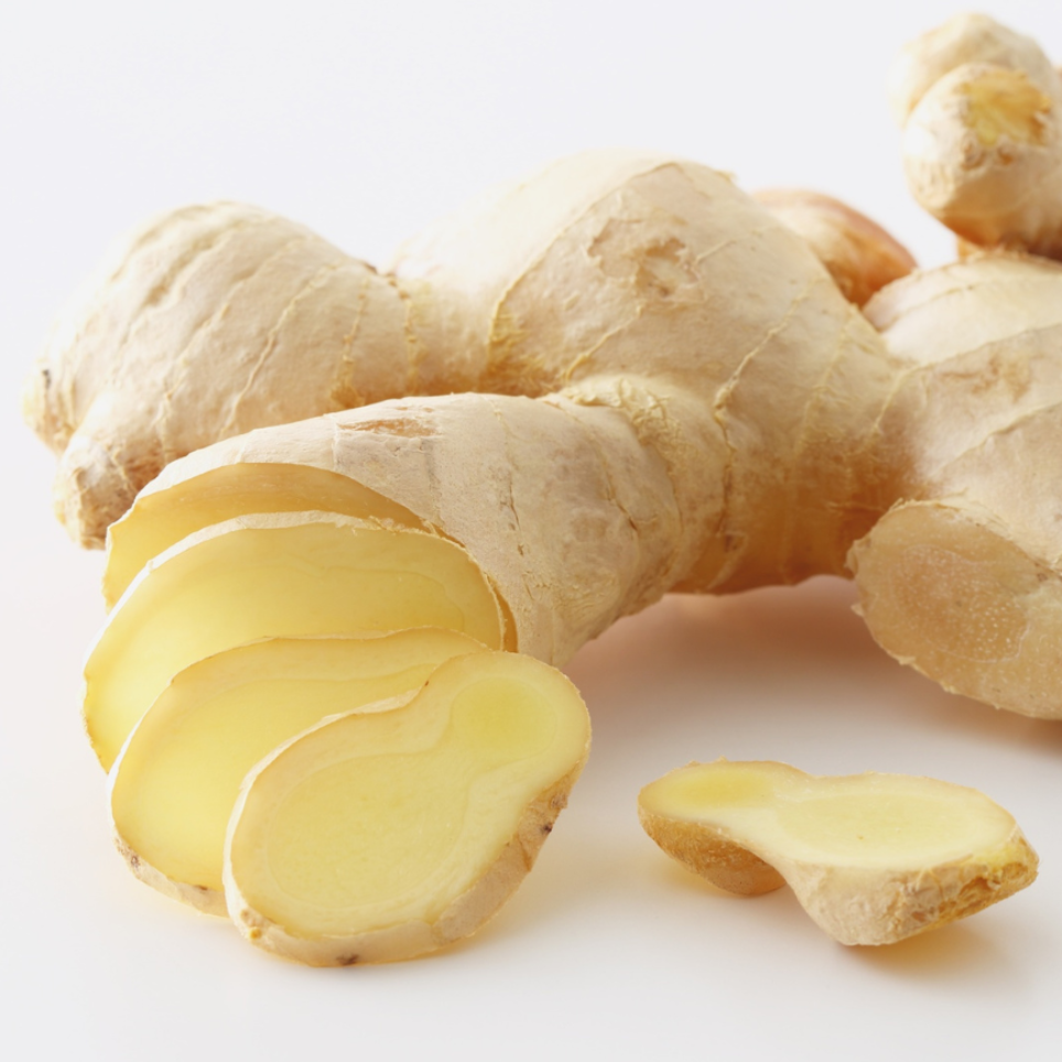 Whole and sliced ginger root on a white background