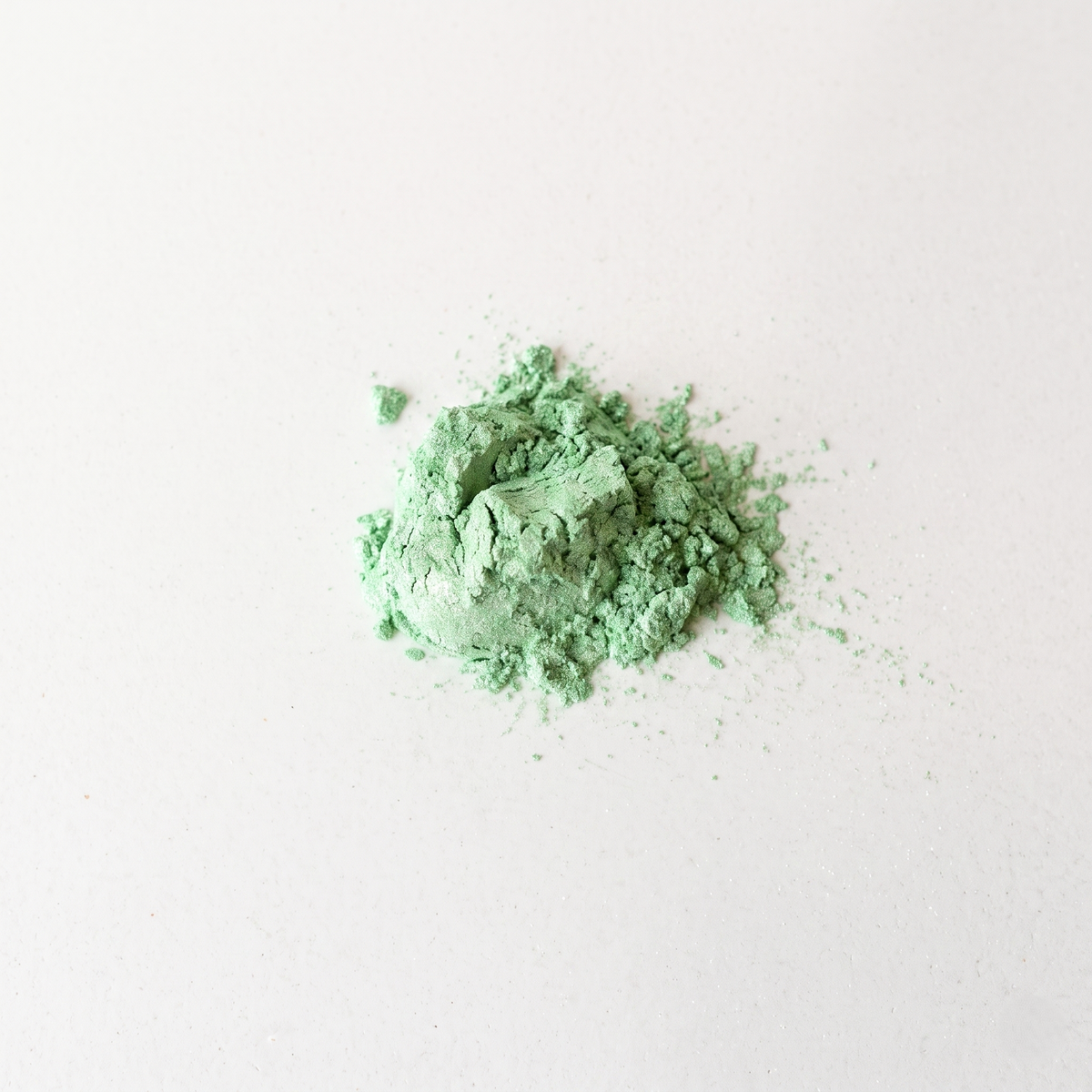Green powder on a white background