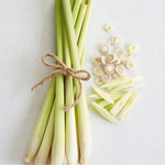 Bundled lemongrass with sliced pieces on a light background