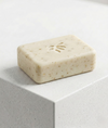 Bar of natural oats soap on a light gray surface
