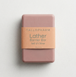 Pink soap bar with a blush label on a light gray background