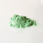 Green powder on a white background